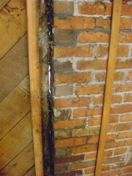 Here is one reason why the attic was so cold. Look at the gap along the side of the chimney. This whole area was foamed with expanding foam.