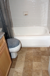Travertine floor and subway tile bathtub surround