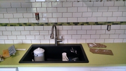 This shows the new sink and how it contrasts well with the new tile and countertop.